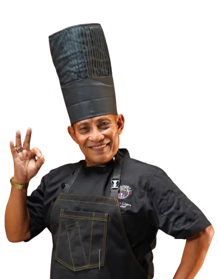 Chef in black uniform and hat making an OK gesture with a smile.